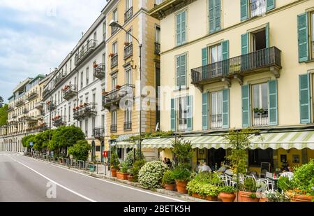 LAKE COMO, ITALY - JUNE 2019: Buildings on the lakefront road through Cadenabbia on Lake Como. On the right is the Bar Iron gate. Stock Photo