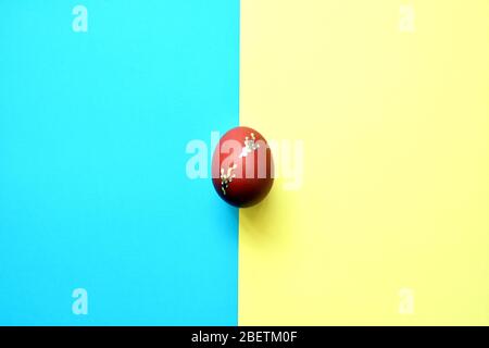 Easter egg on blue and yellow background . Stock Photo