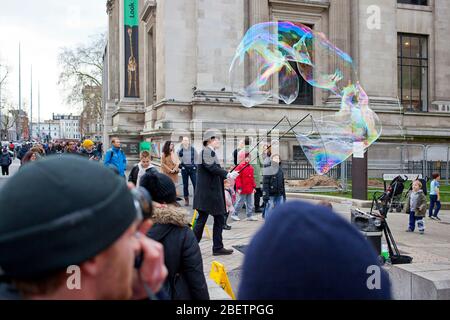Street performer blowing giant soap bubbles Stock Photo
