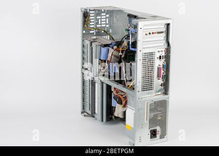 Back side of desktop PC,  desktop computer, inside floppy disk drive, CD drive, hard  disk drive, main board , power supply unit. PC without upper boa Stock Photo