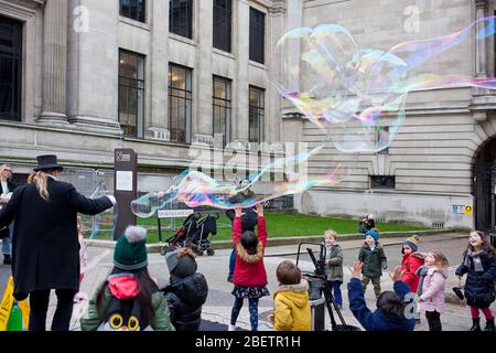 Street performer blowing giant soap bubbles Stock Photo