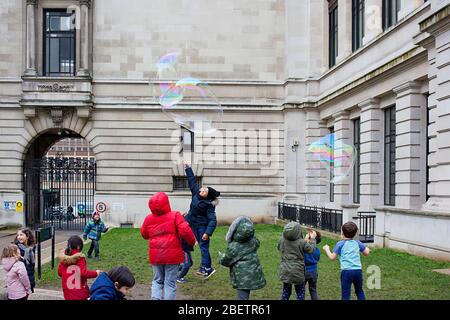 Street performer blowing giant soap bubbles Stock Photo