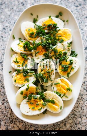 Hard boiled eggs with chives - polish Easter breakfast Stock Photo
