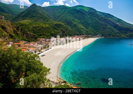 Aerial top view of sandy beach of Tyrrhenian sea bay gulf coast shore of beautiful seaside town village Scilla with green hill and blue sky white clou Stock Photo