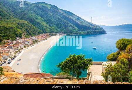 Aerial top view of sandy beach of Tyrrhenian sea bay gulf coast shore of beautiful seaside town village Scilla with green hill and Sicily island backg Stock Photo