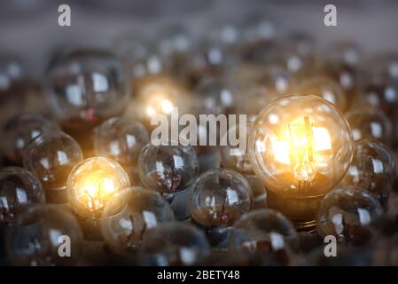 Many little light bulbs. Only a few are lighting. The concept of creative and bright people and their ideas. Stock Photo