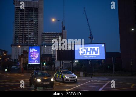 MANCHESTER, UK A billboard with the NHS logo rotated 180 degrees to warn motorists to STAY HOME NOW on Great Ancoats Street at twilight in Manchester city centre on Wednesday 15th April 2020. (Credit: Pat Scaasi | MI News) Credit: MI News & Sport /Alamy Live News Stock Photo