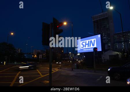 MANCHESTER, UK A billboard with the NHS logo rotated 180 degrees to warn motorists to STAY HOME NOW on Great Ancoats Street at twilight in Manchester city centre on Wednesday 15th April 2020. (Credit: Pat Scaasi | MI News) Credit: MI News & Sport /Alamy Live News Stock Photo