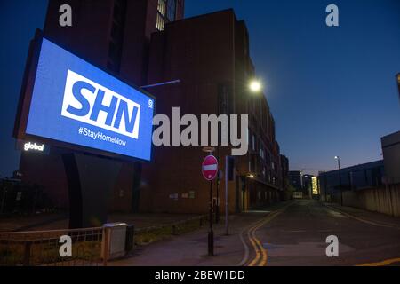 MANCHESTER, UK A billboard with the NHS logo rotated 180 degrees to warn motorists to STAY HOME NOW on Great Ancoats Street at twilight in Manchester city centre on Wednesday 15th April 2020. (Credit: Pat Scaasi | MI News) Credit: MI News & Sport /Alamy Live News Stock Photo