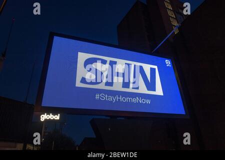 MANCHESTER, UK A billboard with the NHS logo rotated 180 degrees to warn motorists to STAY HOME NOW on Great Ancoats Street at twilight in Manchester city centre on Wednesday 15th April 2020. (Credit: Pat Scaasi | MI News) Credit: MI News & Sport /Alamy Live News Stock Photo