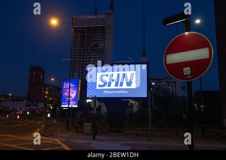 MANCHESTER, UK A billboard with the NHS logo rotated 180 degrees to warn motorists to STAY HOME NOW on Great Ancoats Street at twilight in Manchester city centre on Wednesday 15th April 2020. (Credit: Pat Scaasi | MI News) Credit: MI News & Sport /Alamy Live News Stock Photo