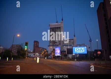 MANCHESTER, UK A billboard with the NHS logo rotated 180 degrees to warn motorists to STAY HOME NOW on Great Ancoats Street at twilight in Manchester city centre on Wednesday 15th April 2020. (Credit: Pat Scaasi | MI News) Credit: MI News & Sport /Alamy Live News Stock Photo