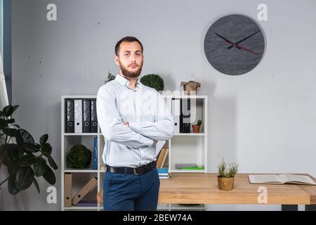 Confidence looks great on him. Business Man With Beard At Modern Office. Profession concept. Leadership. Successful stylish young bearded man in Stock Photo