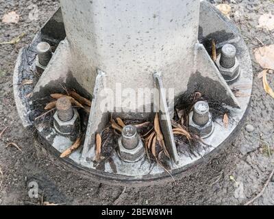 The bottom of the iron pillar is screwed with large nuts Stock Photo