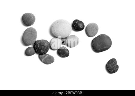 Scattered sea pebbles. Smooth gray and black stones isolated on white background. Top view Stock Photo