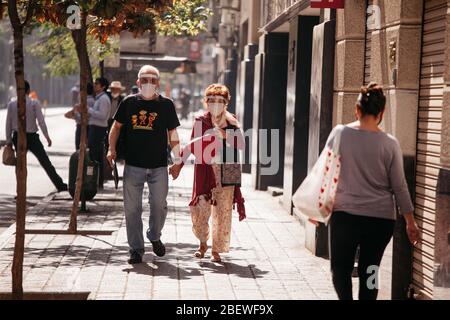 SANTIAGO, CHILE-APRIL 14, 2020 - Elderly couple walk through the streets of downtown Santiago due to the quarantine that affects some communes of the Stock Photo