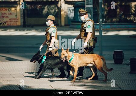 SANTIAGO, CHILE-APRIL 14, 2020 - Police couple patrol the streets due to the quarantine that affects some communes of the city due to the Covid 19 pan Stock Photo
