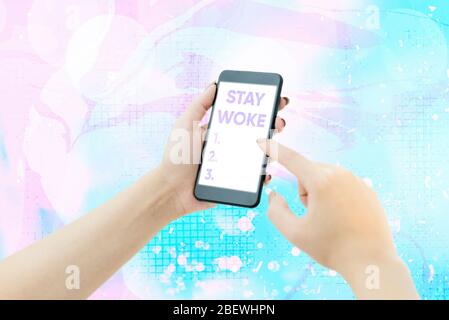 Text sign showing Stay Woke. Business photo showcasing being aware of your surroundings and things going on Keep informed Stock Photo