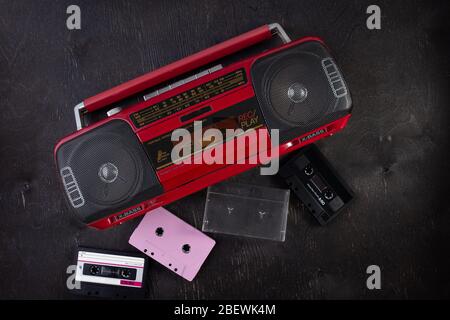 Vintage radio cassette recorder on a dark background. Old retro red radio and cassette player. retro technology Stock Photo