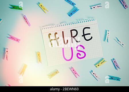 Writing note showing Hire Us. Business concept for Used by resources indicate employee that he is got job Colored clothespin rectangle shaped paper bl Stock Photo