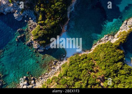 Aerial of secluded beach in Greece. A hidden bay in mediterranean sea. Limni beach on Corfu island. Stock Photo
