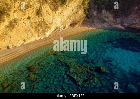 Hidden mediterranean sea beach in Greece. Private secluded beach on ocean shore Stock Photo