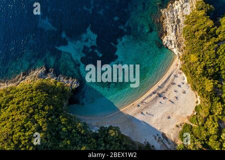 Aerial of secluded paradise beach in mediterranean sea. Hidden Rovinia beach spot in Greece island Corfu. Stock Photo