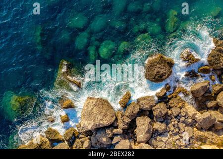 Sea surface aerial. Ocean waves hitting mediterranean shore Stock Photo