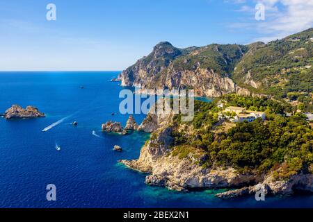 Beautiful mediterranean lagoon aerial landscape. Vivid blue sea with cliffs coast and boats. Nature of Paleokastritsa in Corfu, Greece. Stock Photo