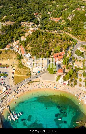 Sunny beach in Greece village Paleokastritsa. Busy beach on a mediterranean sea shore. Corfu island Stock Photo