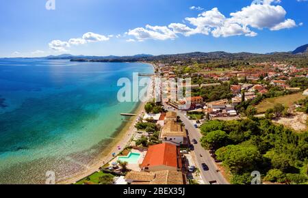 Aerial of greek mediterranean resort town. Kato Agios Markos from a drone. Beautiful beach on a shore of mediterranean sea. Sunny day with vivid blue Stock Photo