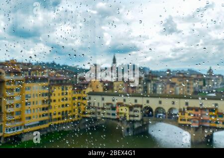 Florence old town with Ponte Vecchio seen through a window on a rainy cloudy day Stock Photo