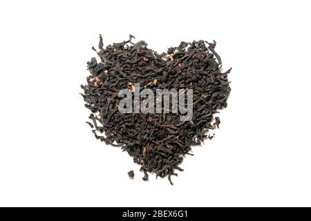 Heap of everyday brew loose dried organic black tea heart shape made with whole leaves isolated on white. Top view. Stock Photo