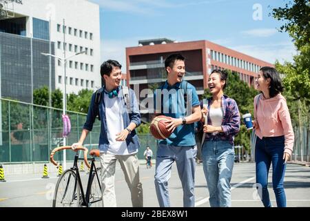 Happy excitement of college students walking in the campus Stock Photo