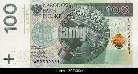 Coronavirus in Poland. Global recession. 100 Polish zloty banknote with a face mask . Polsh economy hit by corona virus covid19 outbreak. Stock Photo