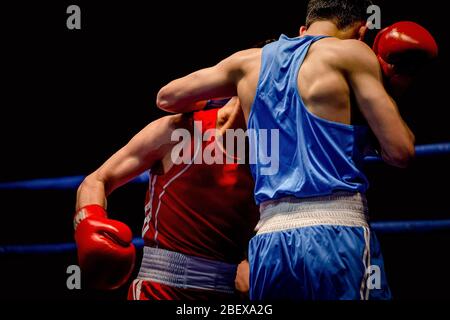 boxing match two boxers in ring on black background Stock Photo