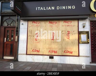 Glasgow, UK, 16 April 2020. Restaurants and cafes with windows all boarded up, closed to the current Coronavirus COVID-19 pandemic health crisis.  Photo credit: Jeremy Sutton-Hibbert/ Alamy Live News. Stock Photo