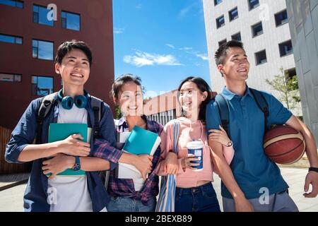 Two couples on the campus of university students Stock Photo