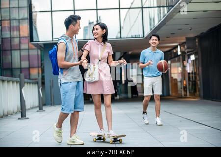 Handsome students goddaughter friend skateboarding Stock Photo
