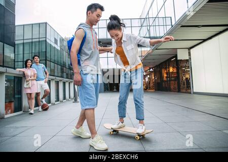 Handsome students goddaughter friend skateboarding Stock Photo