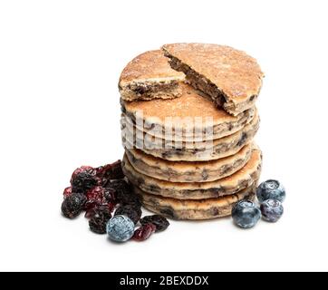Stack  of welsh cakes with dry berries and fresh blueberries isolated on white Stock Photo