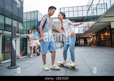 Handsome students goddaughter friend skateboarding Stock Photo