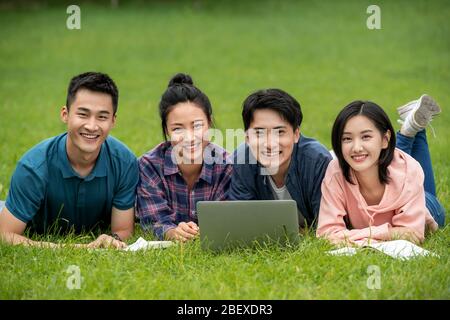 Happy learning of college students on grass Stock Photo