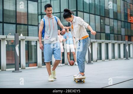 Handsome students goddaughter friend skateboarding Stock Photo
