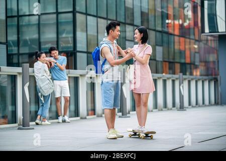 Handsome students goddaughter friend skateboarding Stock Photo