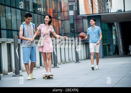 Handsome students goddaughter friend skateboarding Stock Photo