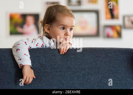 Two year old girl with big eyas portrait, Indoor shoot with natural light Stock Photo