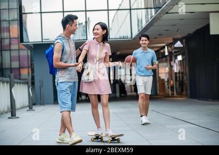 Handsome students goddaughter friend skateboarding Stock Photo