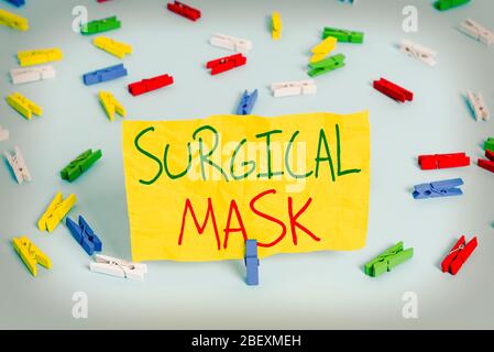 Handwriting text writing Surgical Mask. Conceptual photo worn by health professionals during surgery and during nursing Colored clothespin papers empt Stock Photo