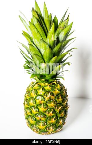 A whole pineapple against a plain white background Stock Photo